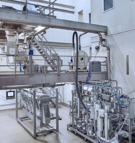 Integrated powder and bulk solids agglomeration system